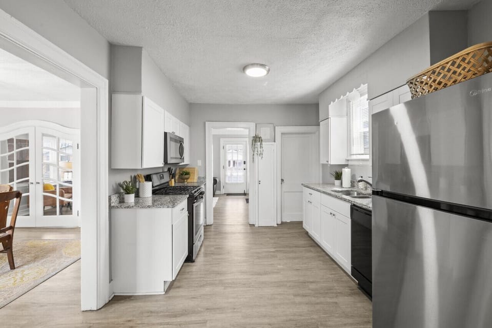 Spacious kitchen with ample counter space and a full-size refrigerator.  Great for cooking and storing your food! 🧊