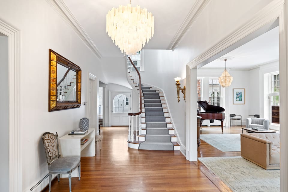 Walk down this beautiful staircase to explore the main floor of this mansion 