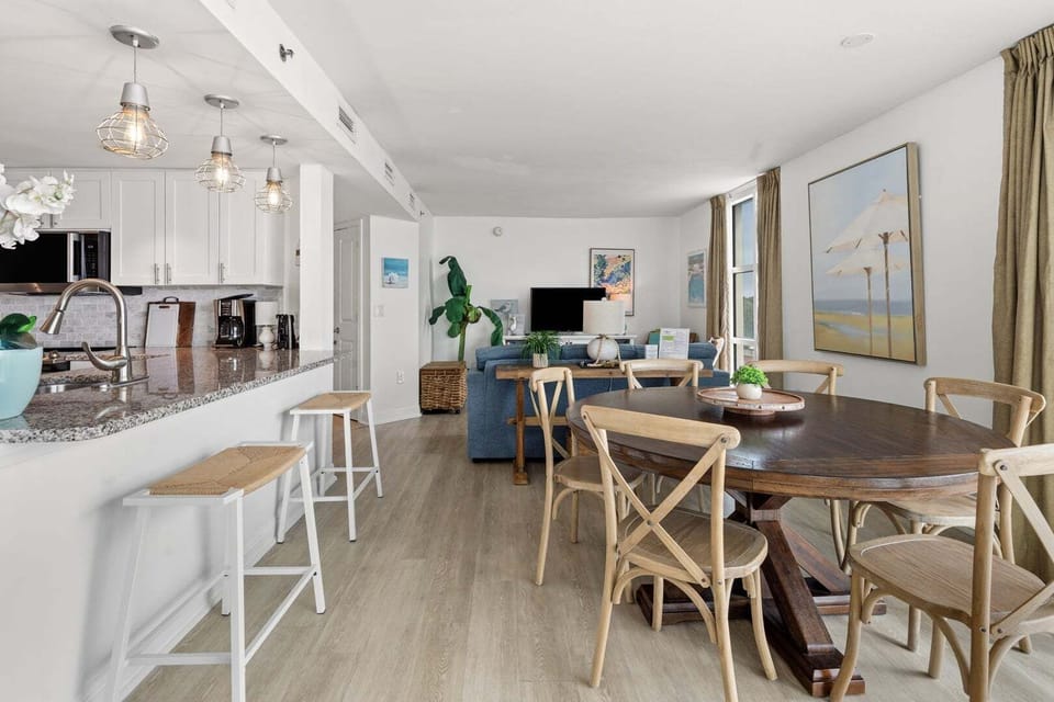 Open living space with an island, dining table and sofa at Seaside Resort 503, a 3-bedroom condo