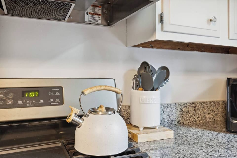 Tea kettle and cooking utensils are at your fingertips.