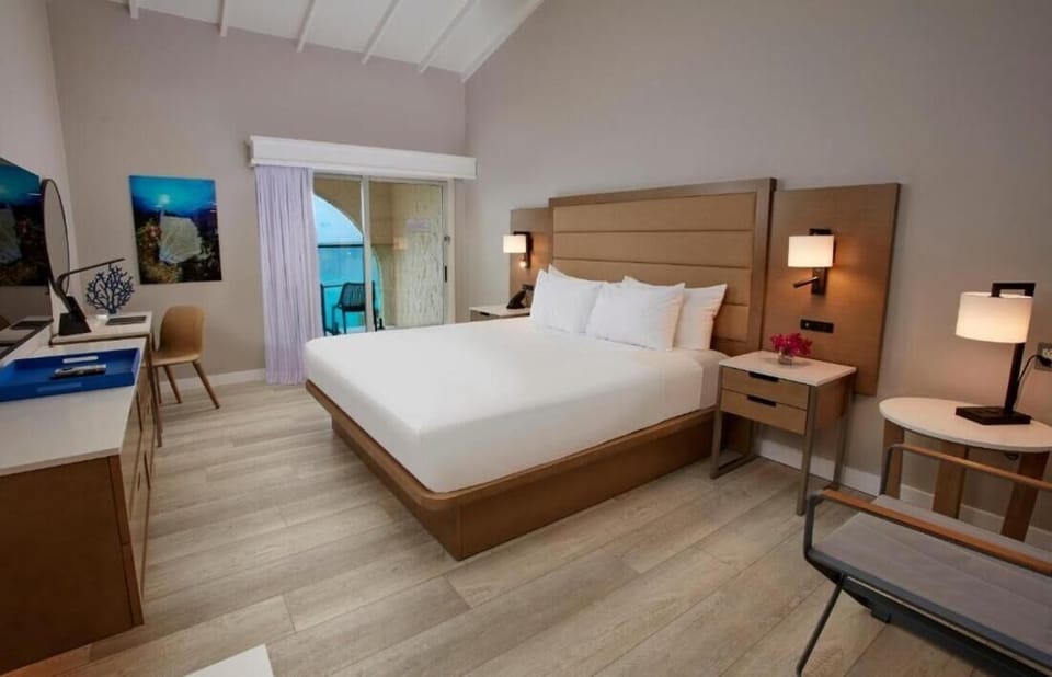 Sink into a serene king bed under soft, warm lighting.