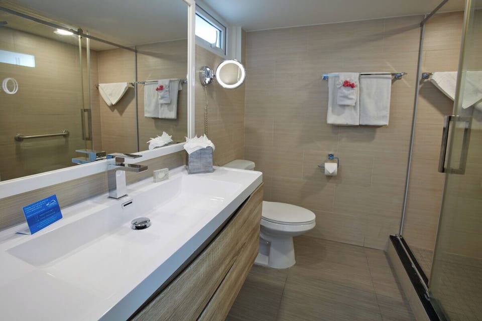 Refresh effortlessly in a bright, modern bath with walk-in shower.