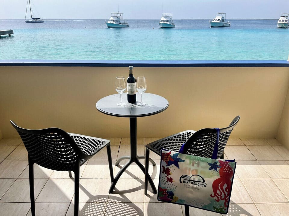 Toast sunsets on your private balcony above turquoise waters.