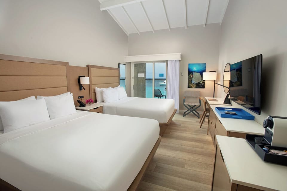 Unwind in crisp beds as ocean breezes drift inside.