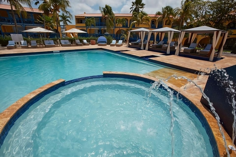 Unwind in bubbling spa waters beside shaded cabana daybeds.