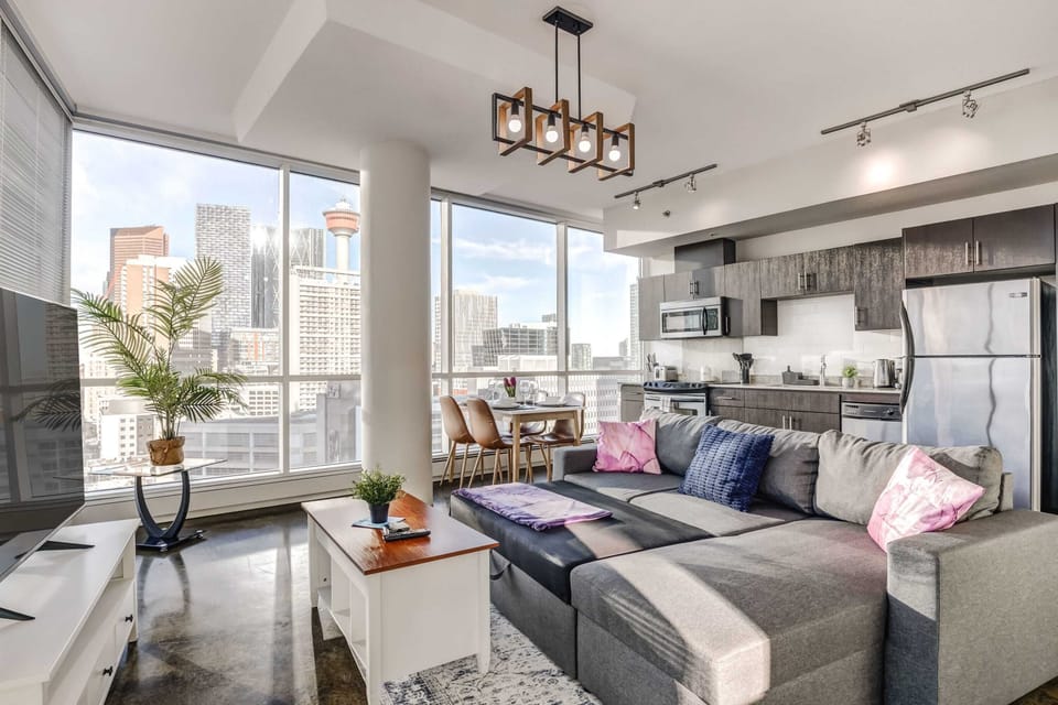 Modern open-concept living room with smart TV and city views