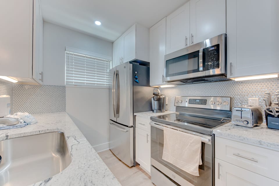 Kitchen - From morning coffee to family dinners, the kitchen has all the amenities you need for a stress-free stay.