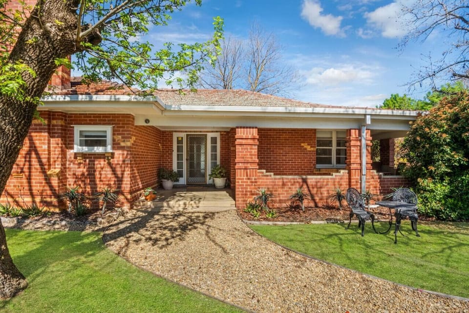Front yard - L shaped enclosed verandah - outdoor seating.