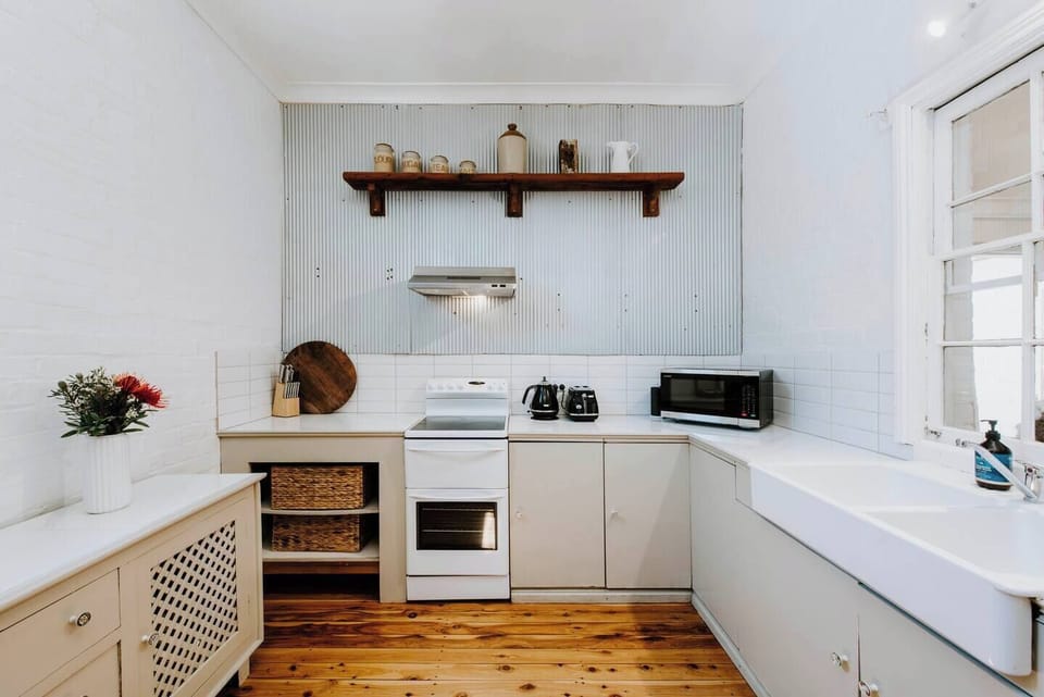 The country-style kitchen comes well equipped with an oven, stove and coffee machine.
