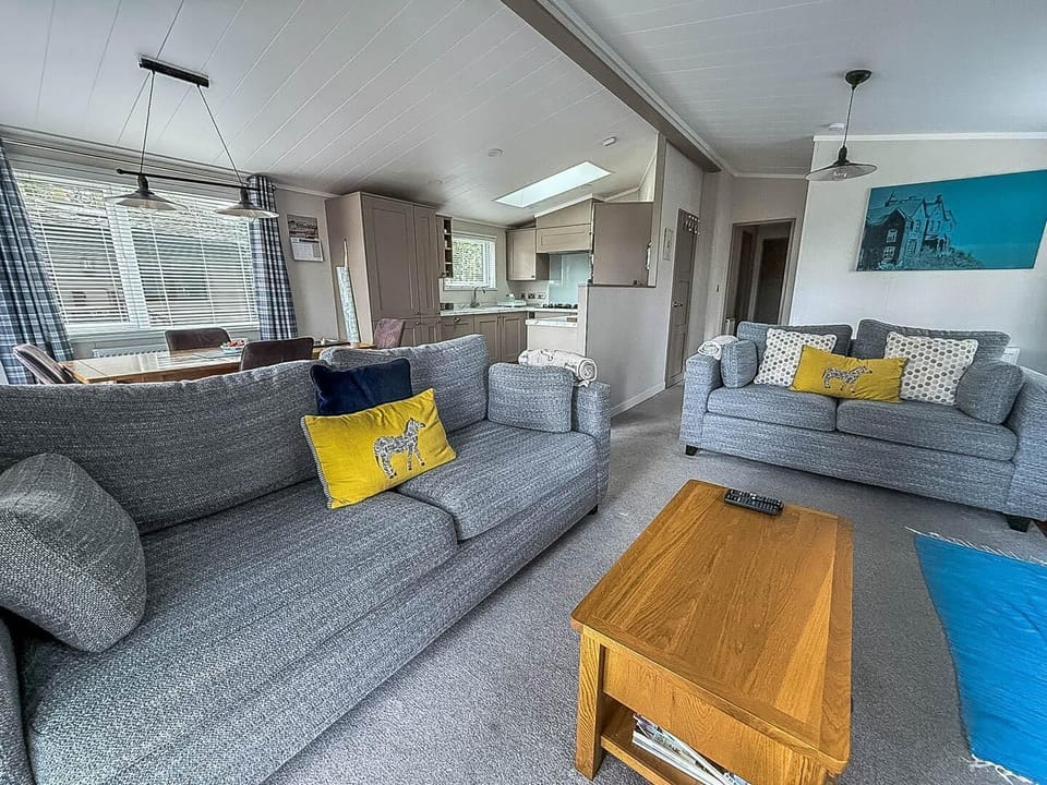 The holiday home living room is the perfect place to relax with a cup of tea after a long day.