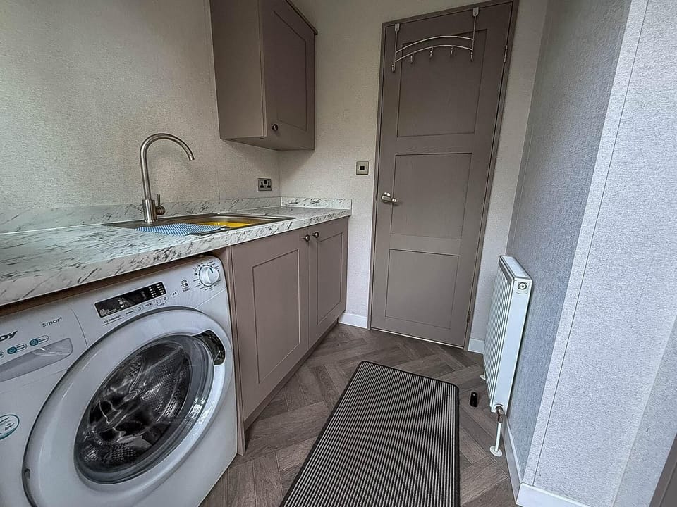 A utility room with a washing machine is a great luxury in this holiday home.