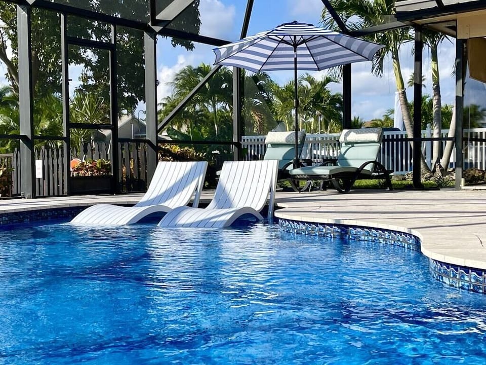Unwind in your private pool as shimmering waterfront views stretch before you, where every sunset feels like a front-row seat to paradise