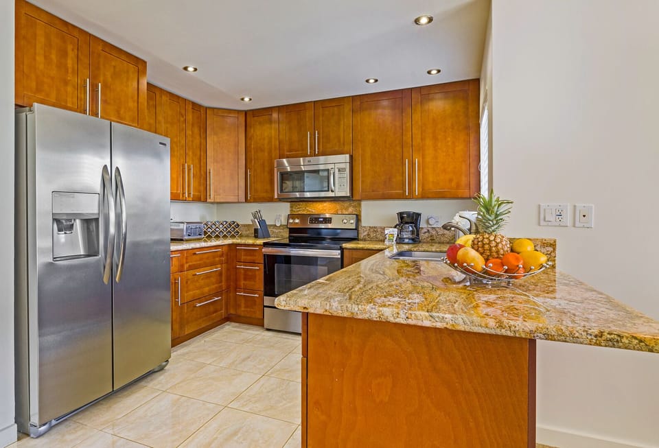 Fully equipped gourmet kitchen with granite countertops, stainless steel appliances, and everything you need for a Maui-style home-cooked meal.