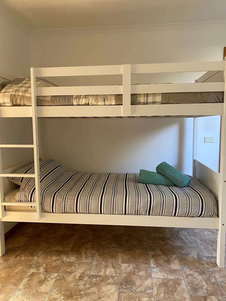 Single bunk bed right near the bathroom and main toilet.
