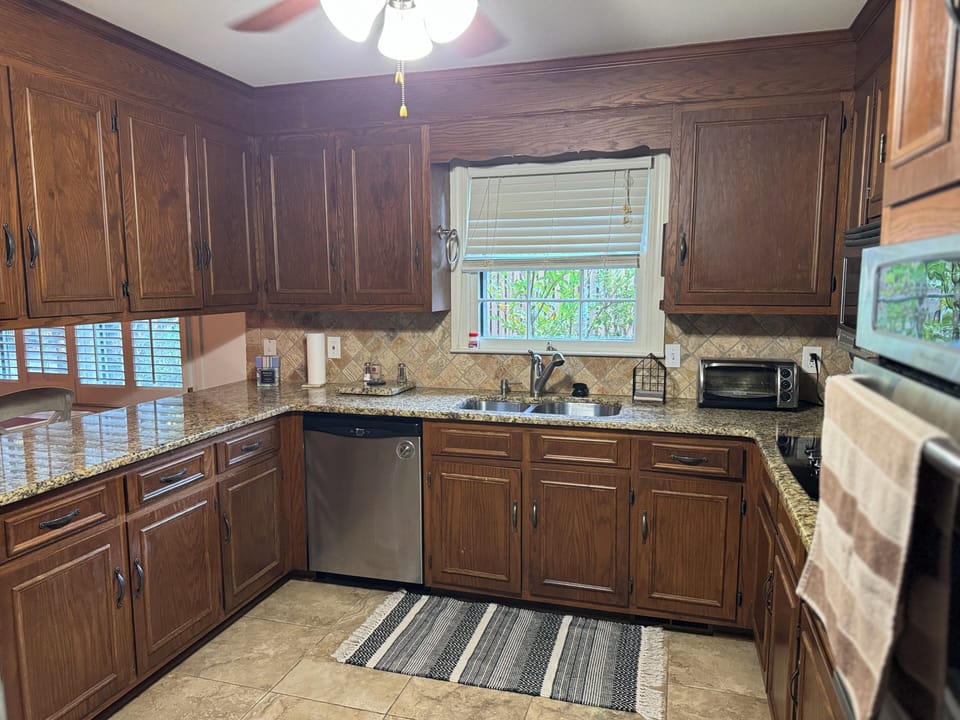 Kitchen- A chef's dream- full of high end appliances, kitchen ware & spices/oil