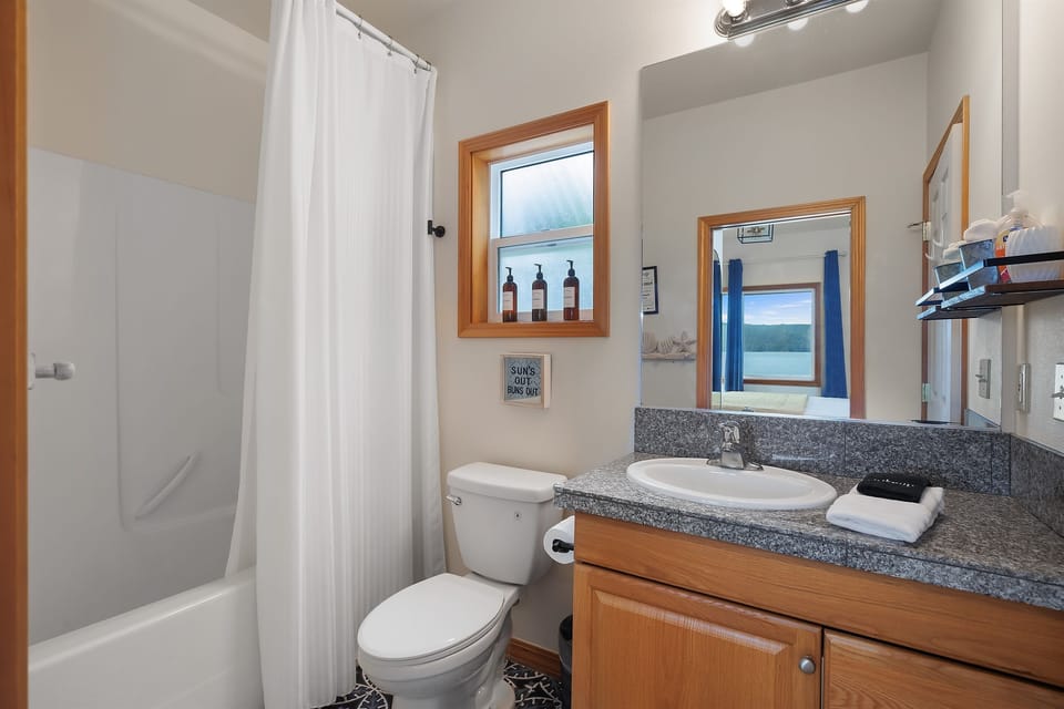 The ensuite bathroom features a convenient tub-shower combo, perfect for a relaxing soak or a quick rinse. We provide body wash, shampoo, and conditioner, so you can freshen up with ease and enjoy a comfortable, hassle-free stay.