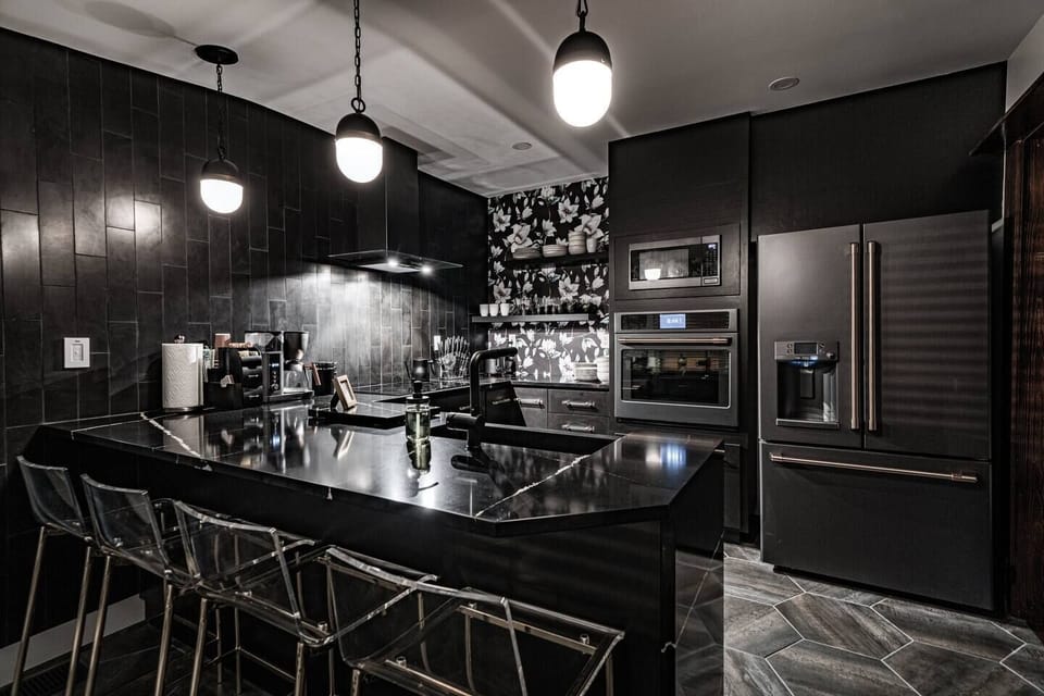 This Matte Black kitchen sets the tone for a luxury stay