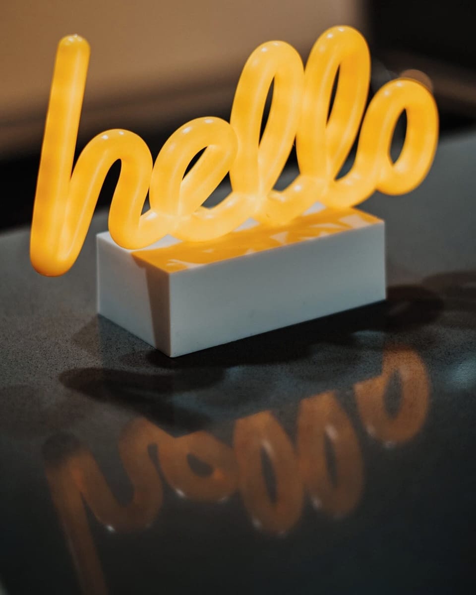 Feel instantly at home as the warm glow of the 'hello' sign greets you upon entry, enveloping the space in a cozy and welcoming ambiance.
