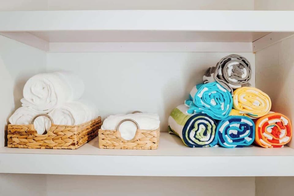 Discover the blend of functionality and elegance in our bathroom, where pristine white and lively colored towels await your convenience.