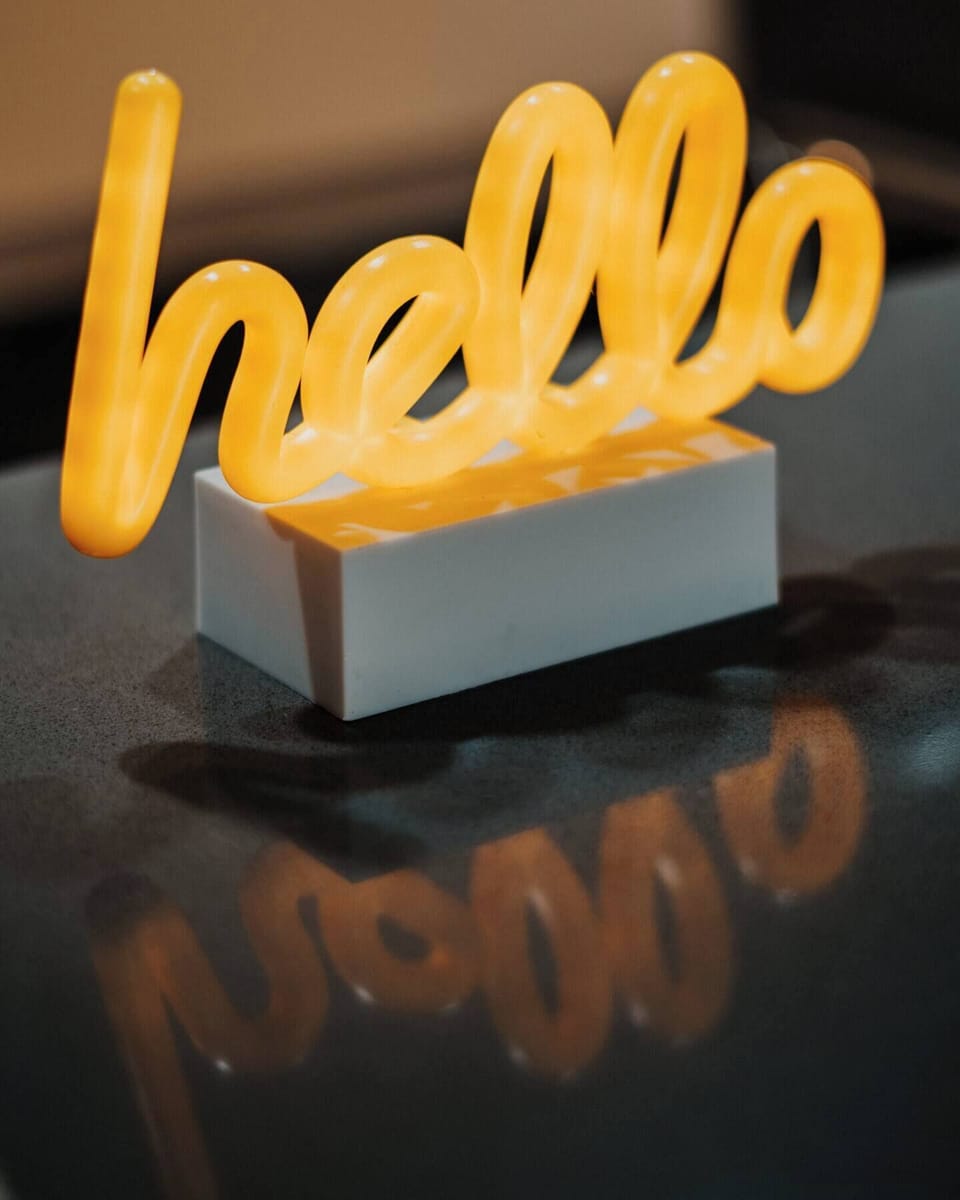 Allow the warm glow of the welcoming 'hello' to guide you towards a tranquil and comfortable experience from the moment you enter.
