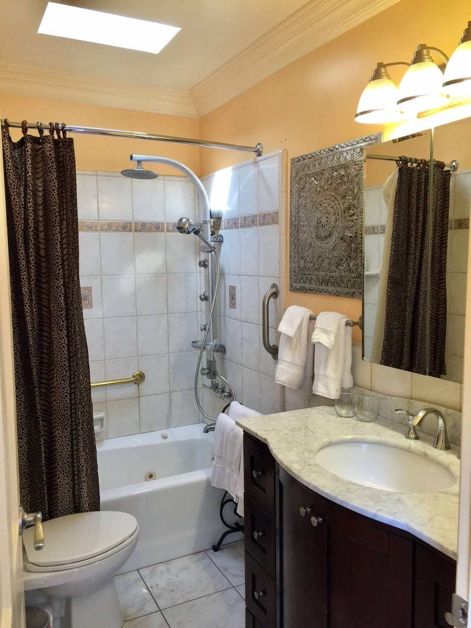 Bathroom with multi jet shower and handheld.  Fluffy white towels.