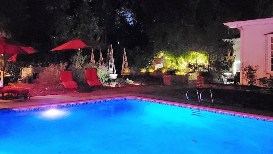 Night time lights pool and brick patio areas
