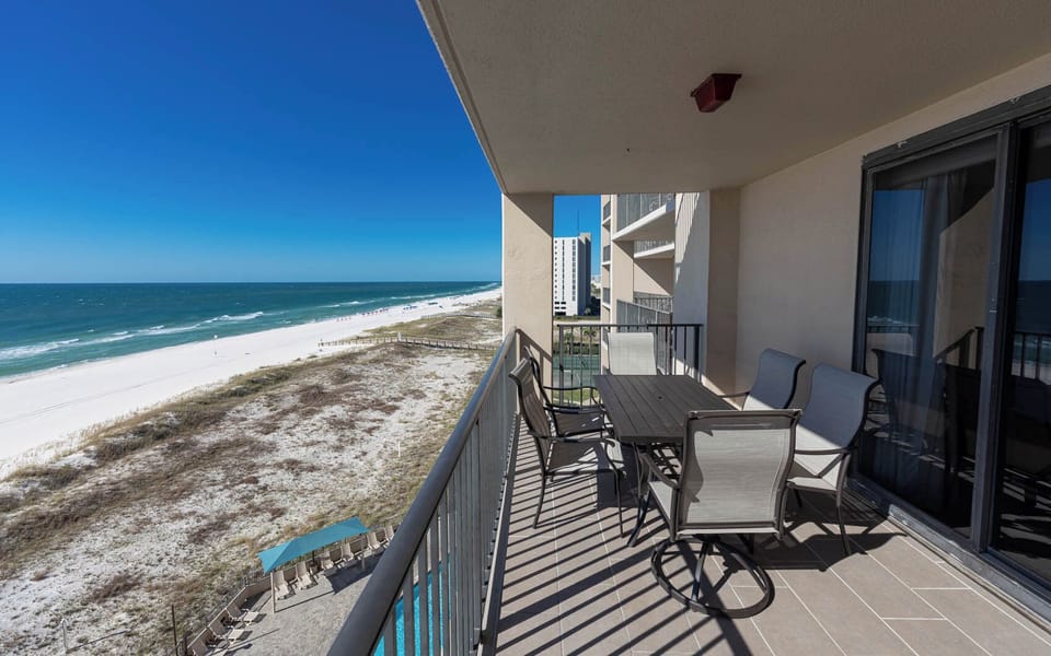 Savor meals at the outdoor table while enjoying the expansive views of the coastline and inviting waters below