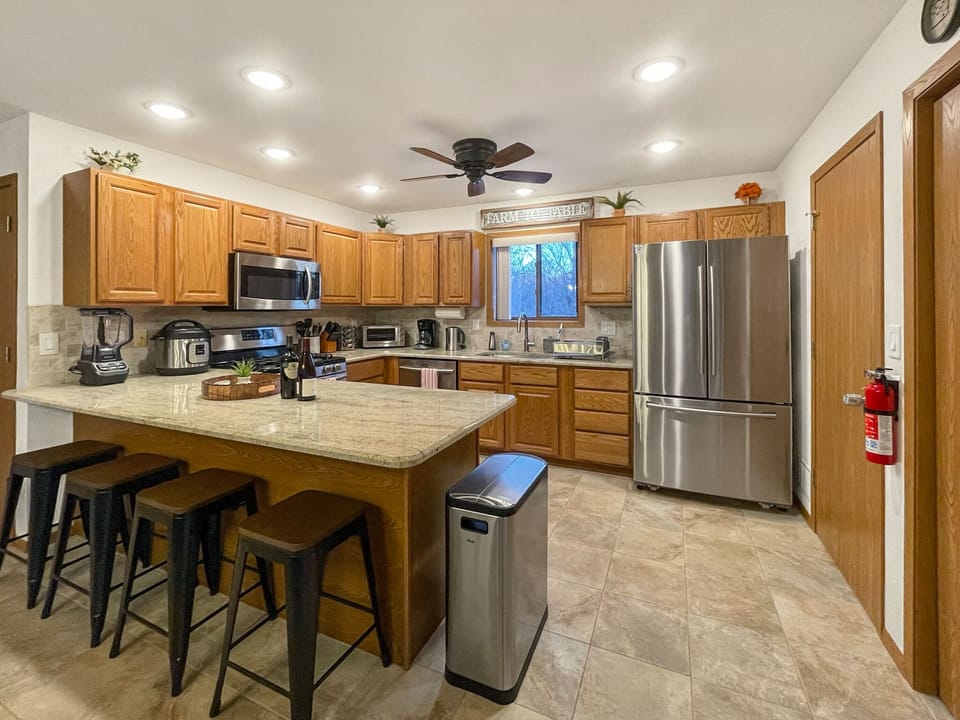 Spacious, open kitchen w/ modern stainless steel appliances and breakfast bar!