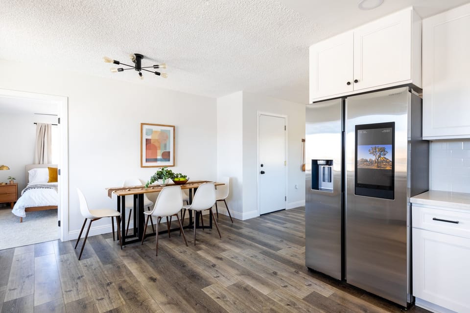 Kitchen with smart fridge with bluetooth speakers.
