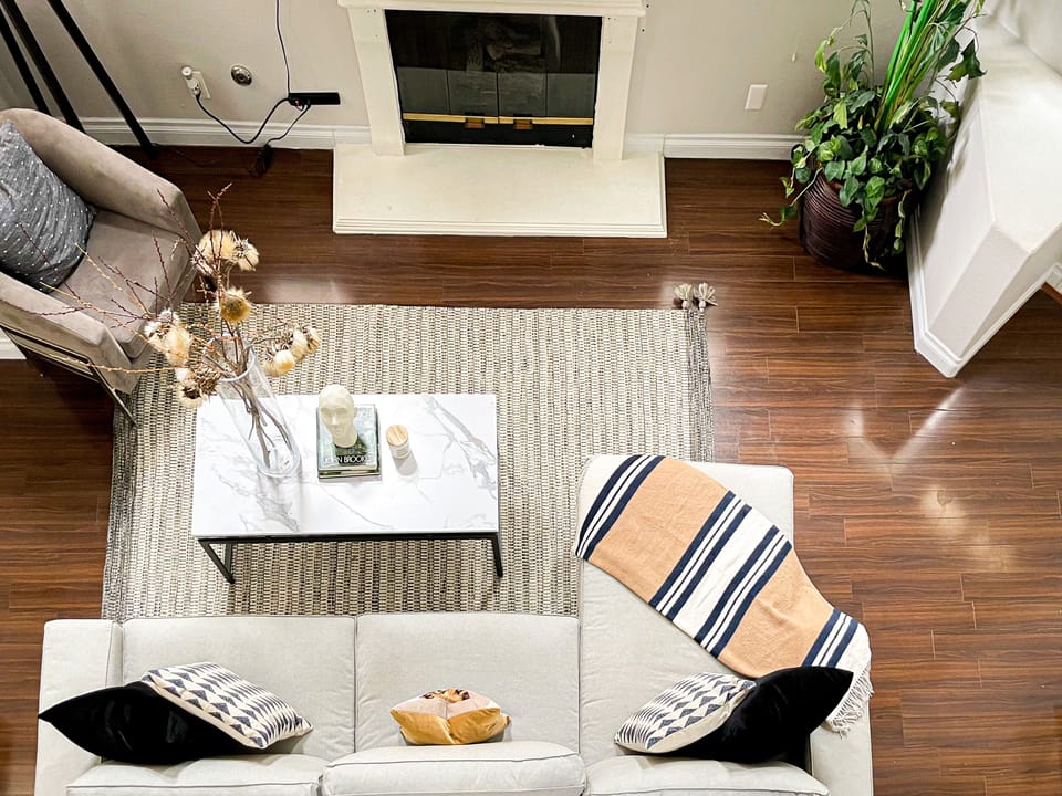 Spacious and cozy living room comes with a L-shaped couch, 58" 4K HDTV and books