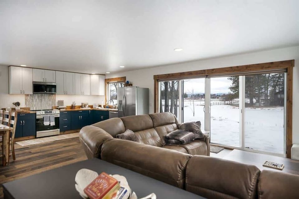 Living area and full kitchen with spring creek view