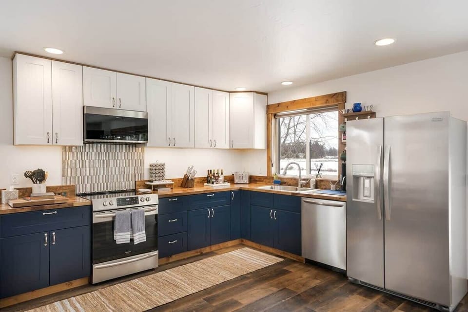 Fully equipped kitchen with cooking basics, spices, drip coffee maker, dishware/flatware, paper towels/trash bags blender, and toaster