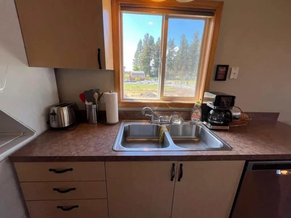Fully equipped kitchen with cooking basics, spices, drip coffee maker, dishware/flatware, paper towels/trash bags blender, and toaster
