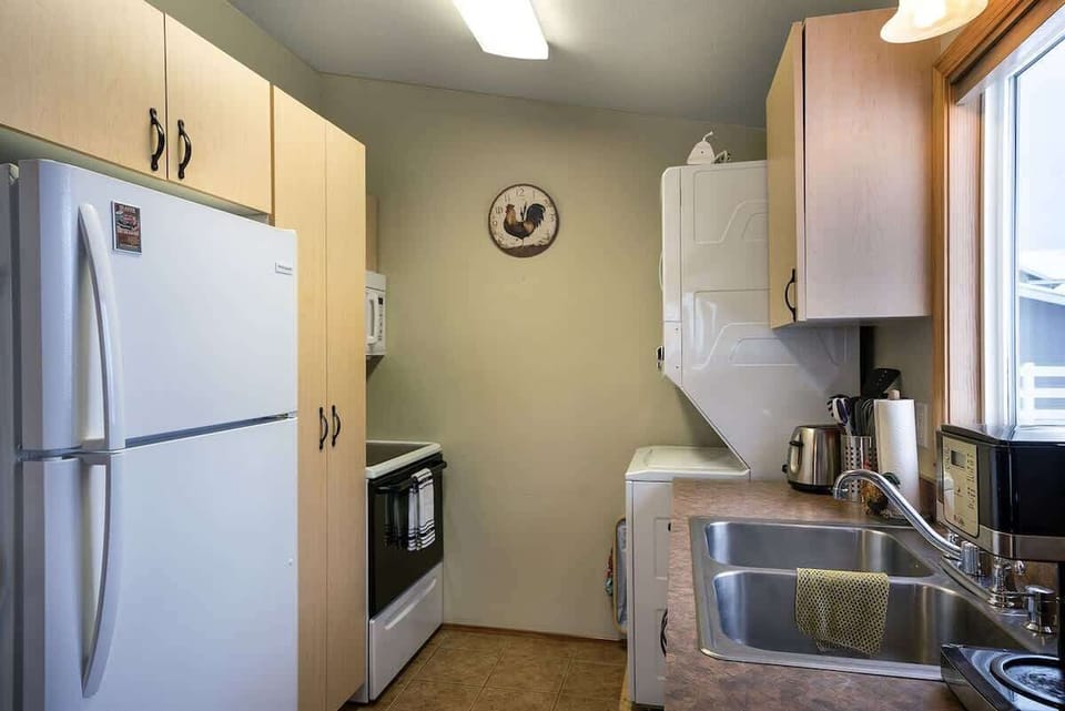 Fully equipped kitchen with cooking basic and Laundry area with washer and dryer