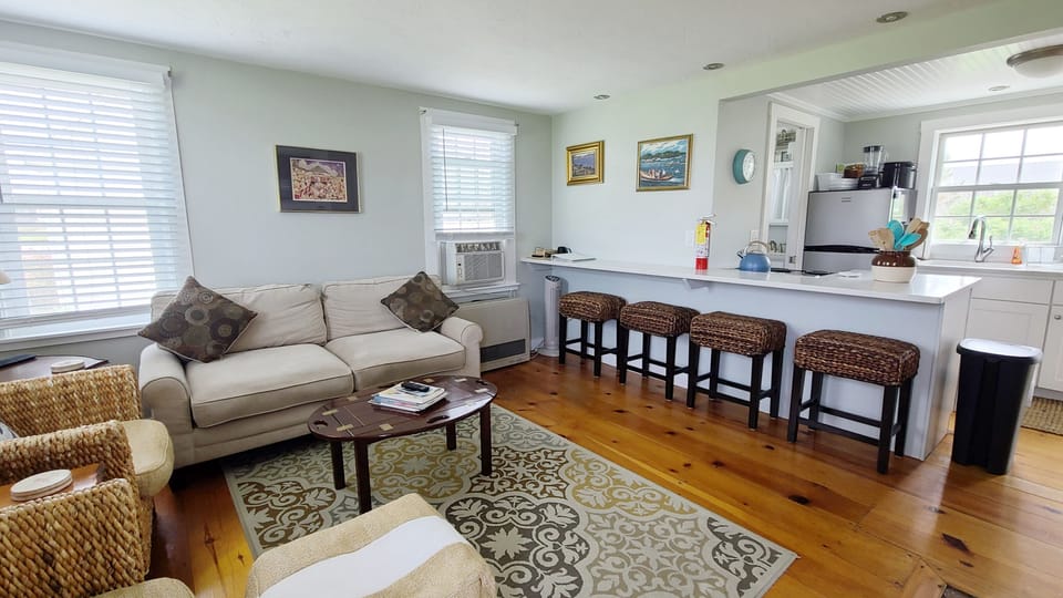 Living room with counter seating and kitchen beyond