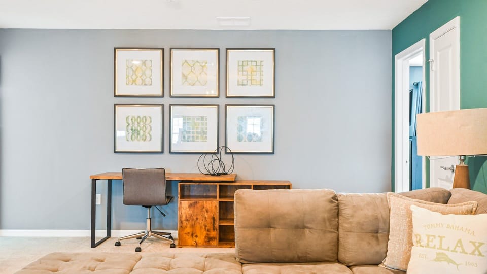 Cozy workspace with stylish desk, comfortable chair, and modern wall art for a relaxing vibe.