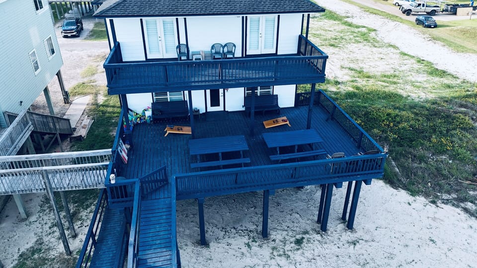 Main balcony has 2 picnic tables, blue tooth speaker, and games for the kids.
