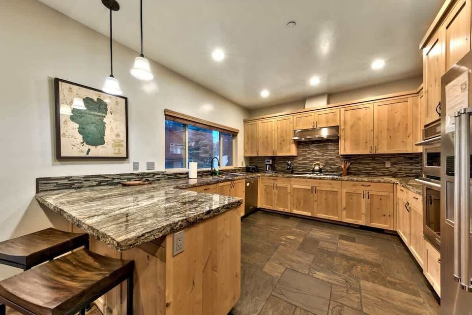 Fully equipped kitchen with cookware, bakeware, and dinnerware for preparing and enjoying a large meal. 

Gas range, and the coffee maker is a standard drip type, with a washable filter.