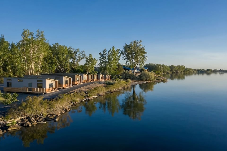 Wake up to serene waterfront cabins and endless blue skies.