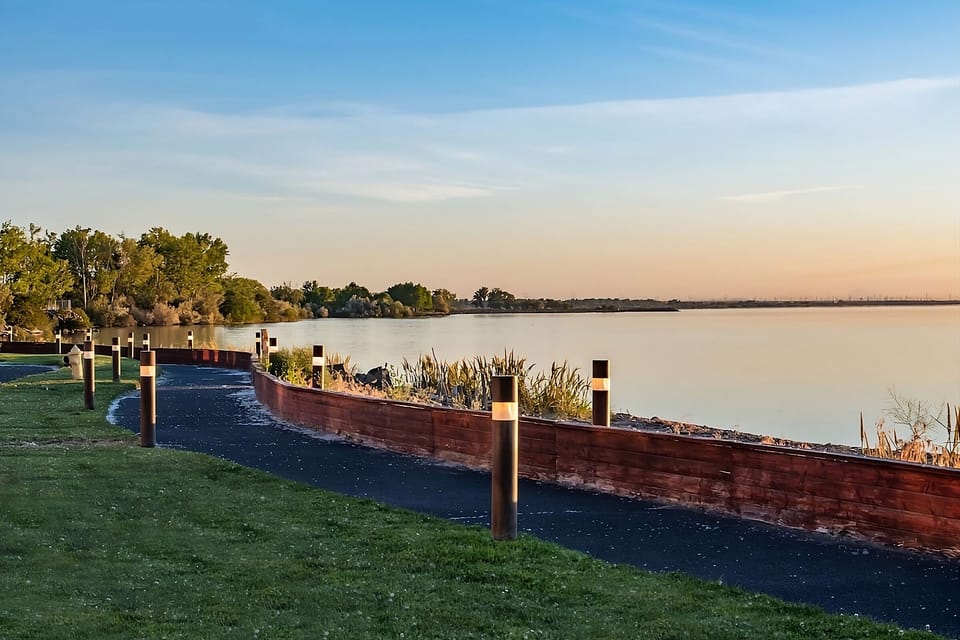 Stroll the waterfront path with glowing lights at dusk.