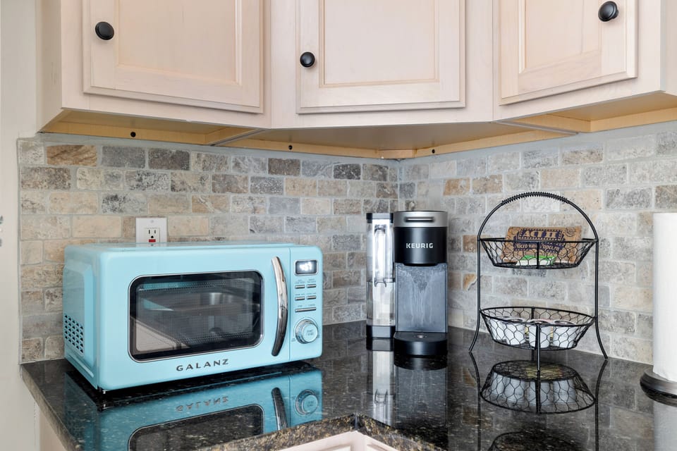 Apartment kitchenette with quartz counters.
