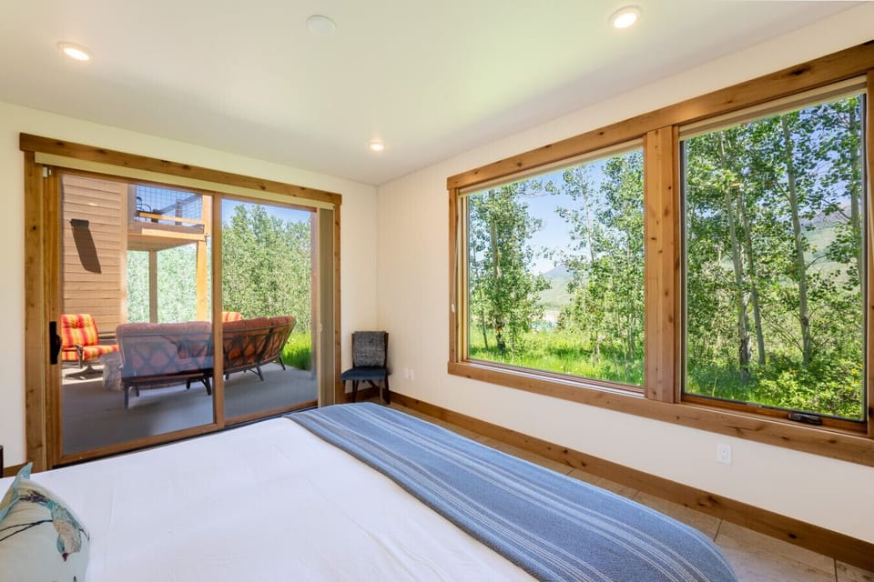 Primary bedroom #3 on the lower level offering a king size bed and patio access