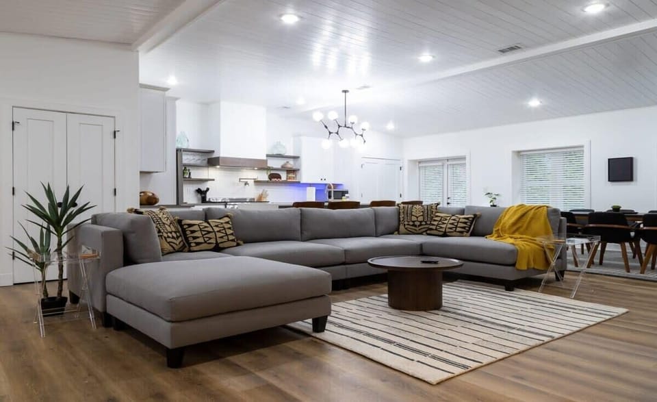 Beautiful open concept living space with beam-clad vaulted ceilings.