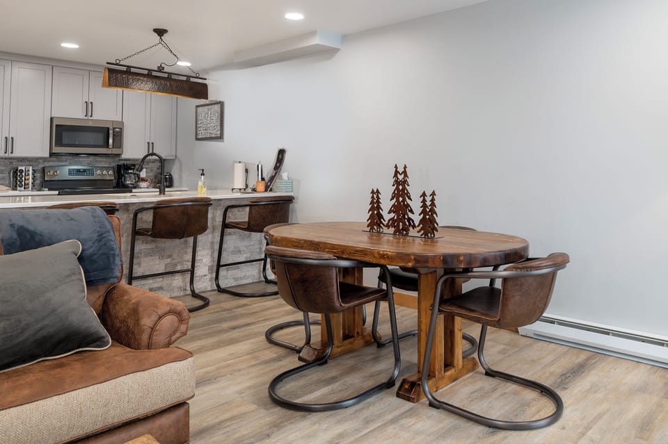 Gather around your rustic dining table for memorable meals, with a fully equipped kitchen and cozy living space just steps away.