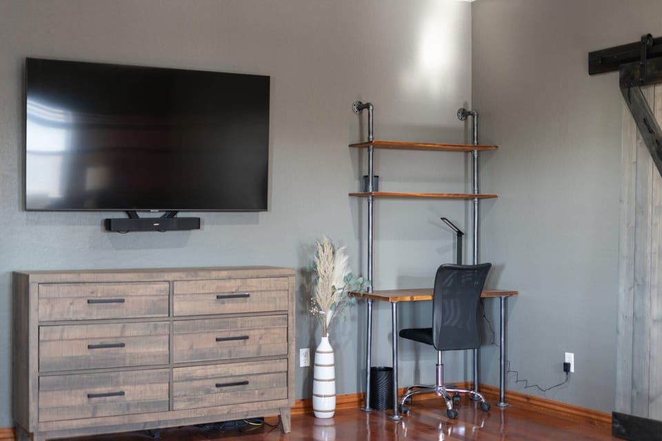 Oversized Owners Suite with King Sized Bed and a built in desk with office chair. Private ensuite bathroom, tiled walk in shower, soaking bathtub, double sinks and Samsung Smart TV.