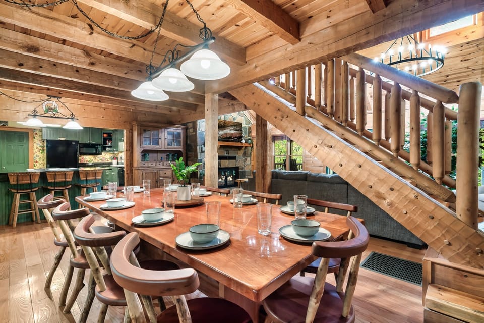 The cabin's large dining room table with seating for 10 creates a comfortable space to bring the group together and make wonderful memories.