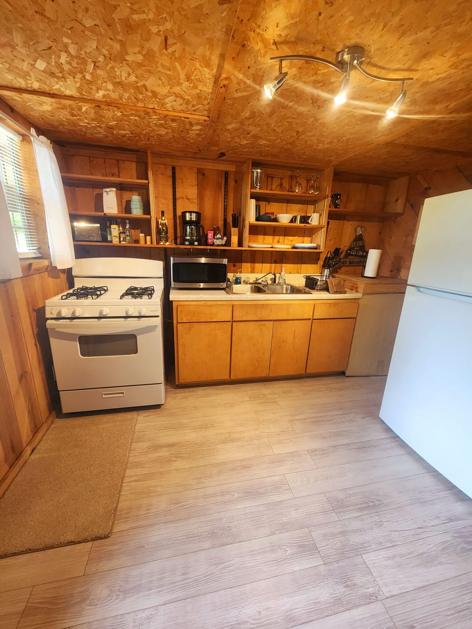 Kitchen offers full size range, refrigerator and microwave.