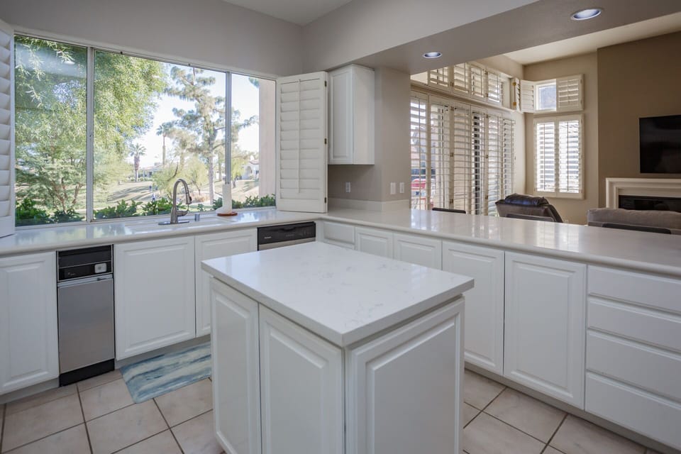 Full kitchen with island and view to golf course.