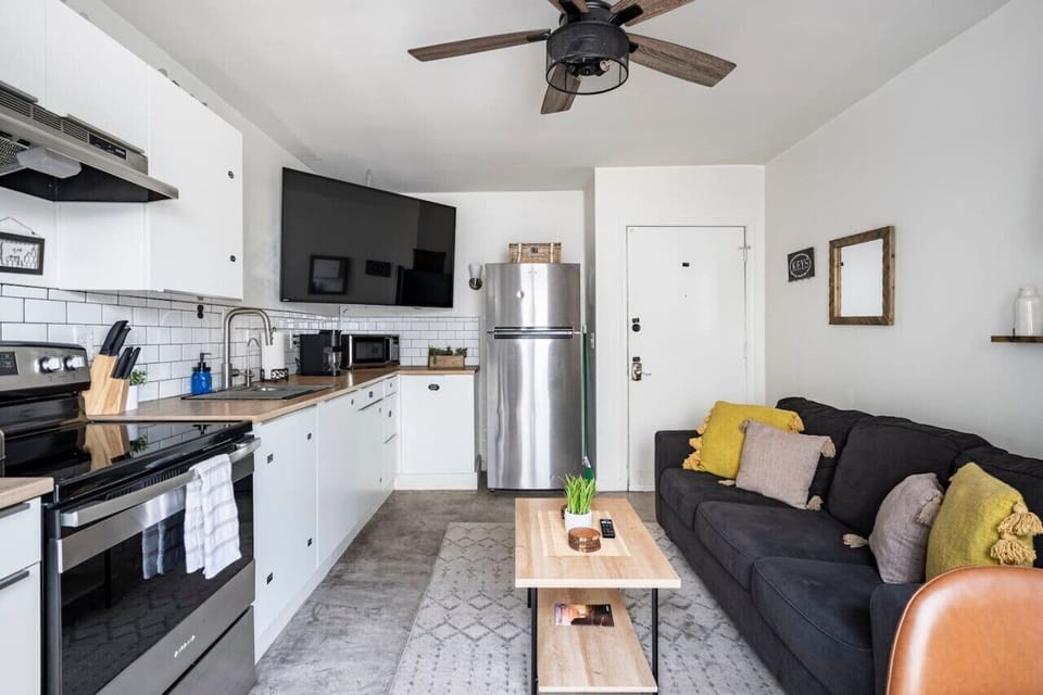 The plush couch beckons you to curl up with a good book, while the sleek TV above the fridge promises hours of binge-worthy entertainment.