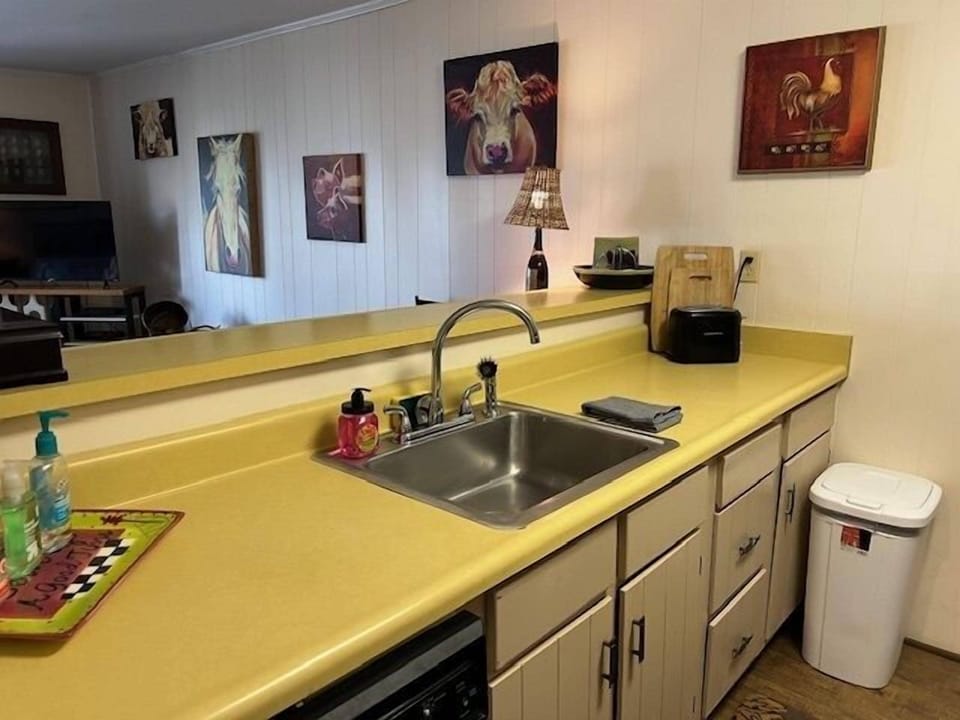 Spacious kitchen counter with sink, perfect for meal prep and socializing.